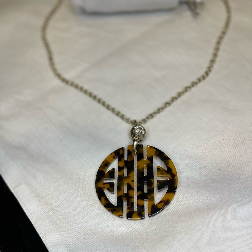 Chico’s. 30”necklace w/tortoise pendant w/matching tortoise scroll bracelet.